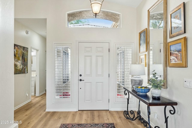 entryway featuring baseboards and wood finished floors