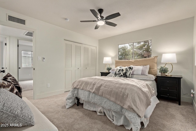 carpeted bedroom featuring ceiling fan and a closet