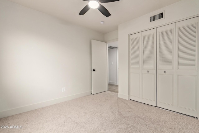 unfurnished bedroom with a closet, ceiling fan, and light colored carpet