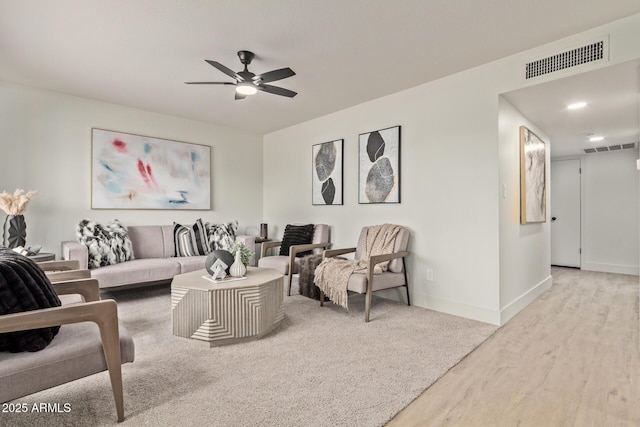 living room featuring light wood-type flooring and ceiling fan