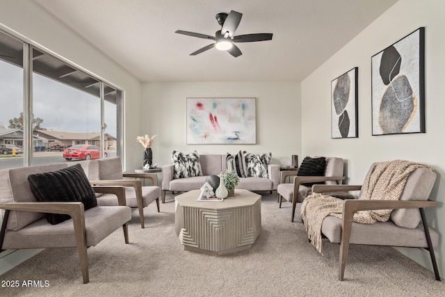 carpeted living room with ceiling fan