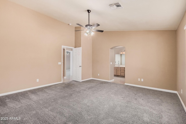 3343 W Lone Cacuts Dr, Phoenix, AZ 85027 - unfurnished bedroom featuring arched walkways, vaulted ceiling, carpet, ensuite bathroom, and a ceiling fan