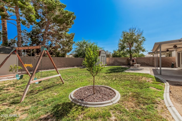 3343 W Lone Cacuts Dr, Phoenix, AZ 85027 - fenced backyard with a storage shed, a playground, a patio area, and a ceiling fan