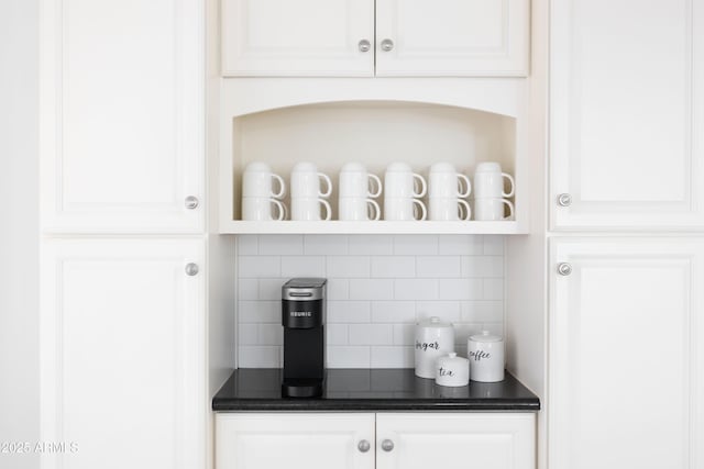 bar featuring white cabinetry and backsplash