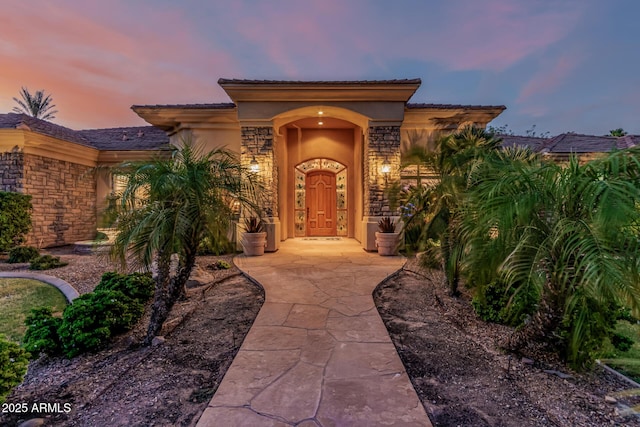 1758 E Carver Rd, Tempe, AZ 85284 - exterior entry at dusk featuring stucco siding and stone siding