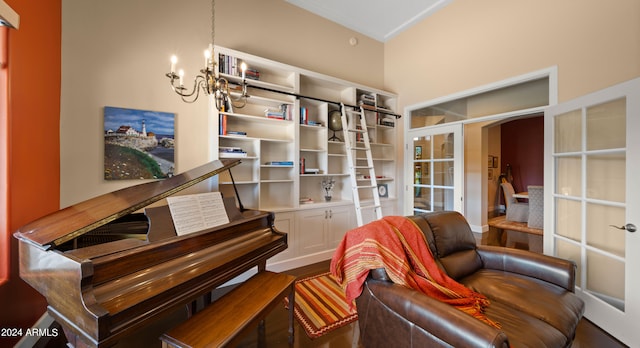 sitting room with french doors and an inviting chandelier