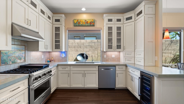 kitchen featuring white cabinetry, stainless steel appliances, and beverage cooler