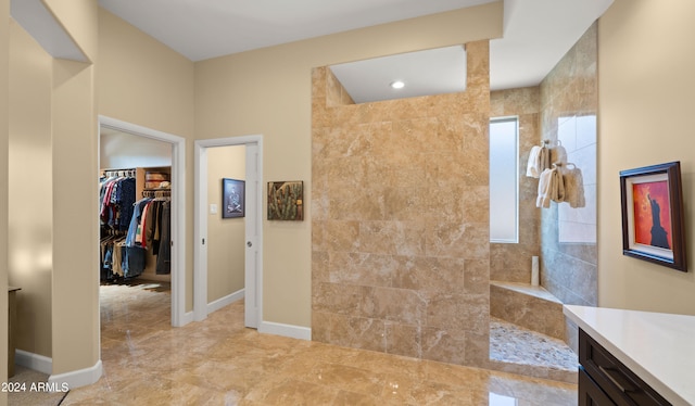 bathroom with vanity and tiled shower