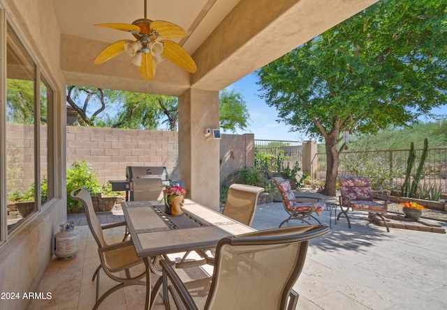 view of patio / terrace with ceiling fan and a grill