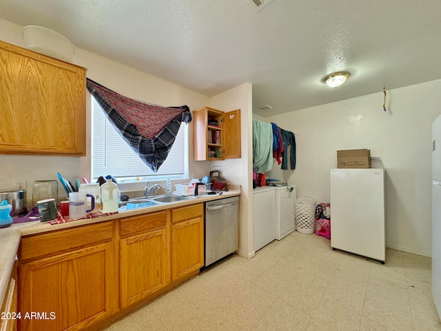 kitchen with white fridge, washer and dryer, dishwasher, a textured ceiling, and sink