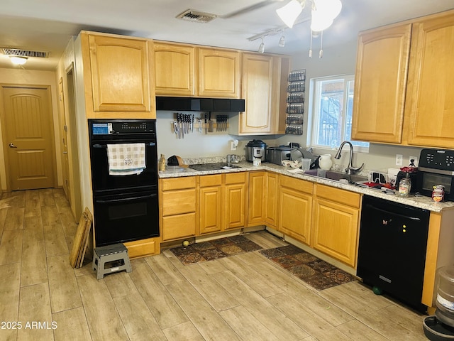 2185 W Greasewood St, Apache Junction, AZ 85120 - kitchen with black appliances, light brown cabinets, and light wood-style floors