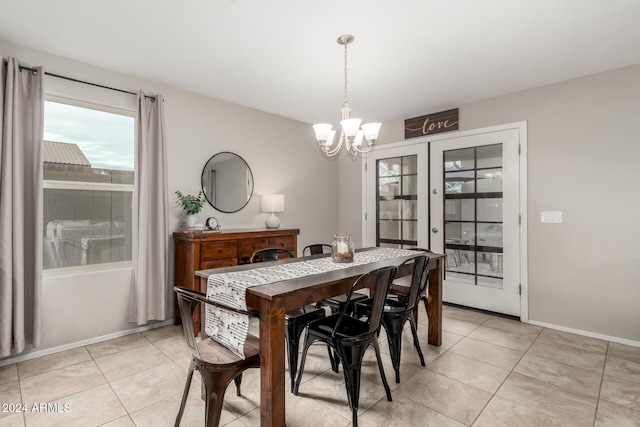 tiled dining space with french doors and an inviting chandelier