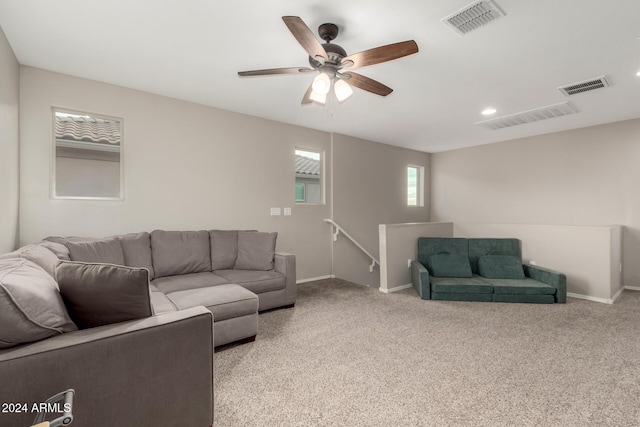 carpeted living room featuring ceiling fan