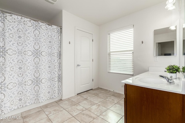 bathroom featuring tile patterned flooring and vanity