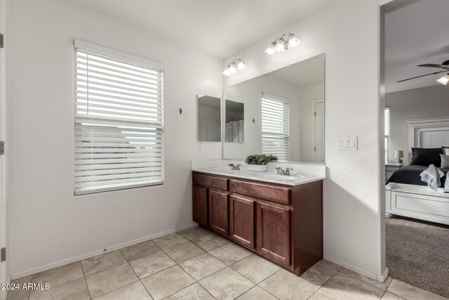 bathroom with tile patterned flooring, vanity, and ceiling fan