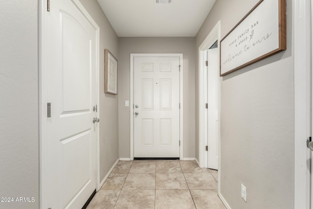 doorway to outside featuring light tile patterned flooring