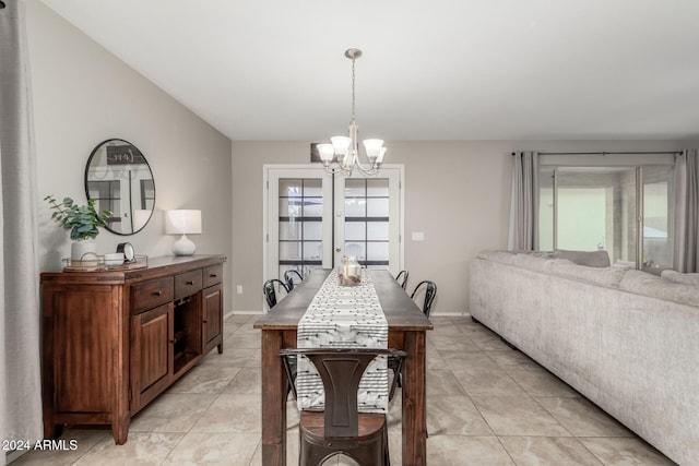 dining room with french doors and an inviting chandelier