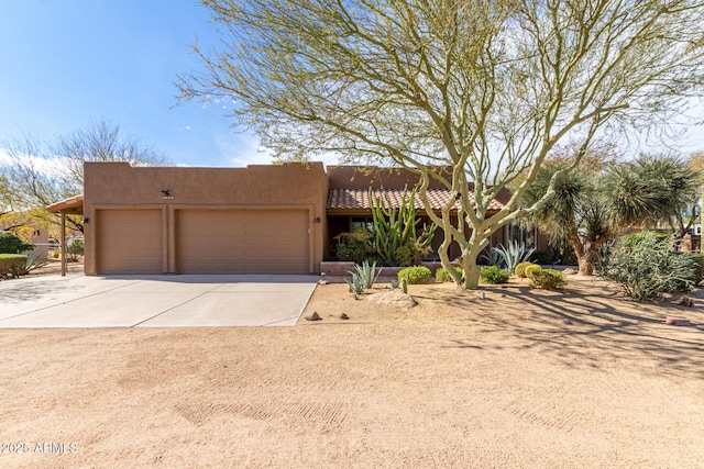 adobe home featuring a garage