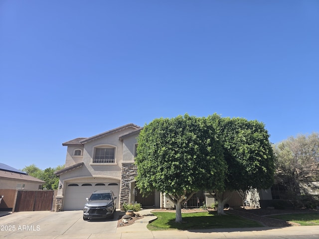 14604 W Banff Ln, Surprise, AZ 85379 - view of front facade with driveway, a garage, stone siding, and stucco siding