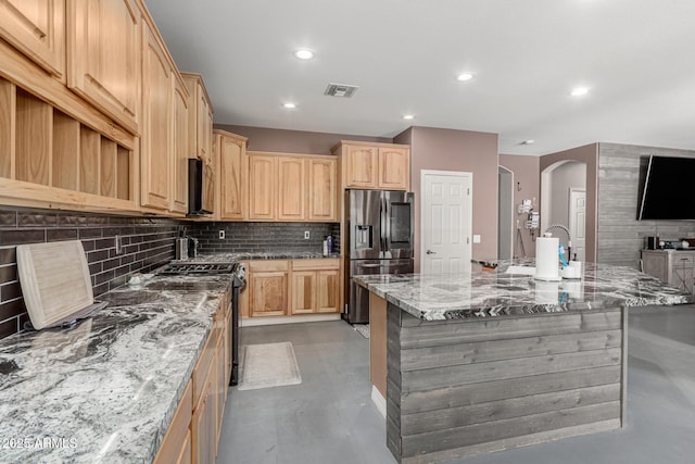 14604 W Banff Ln, Surprise, AZ 85379 - kitchen featuring stainless steel fridge with ice dispenser, finished concrete flooring, decorative backsplash, arched walkways, and recessed lighting