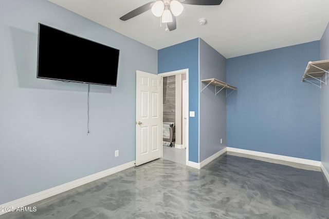 14604 W Banff Ln, Surprise, AZ 85379 - unfurnished bedroom featuring concrete floors, baseboards, and ceiling fan