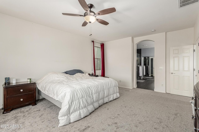 14604 W Banff Ln, Surprise, AZ 85379 - carpeted bedroom with arched walkways, baseboards, a ceiling fan, and ensuite bath