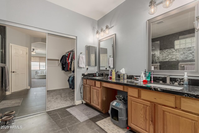 14604 W Banff Ln, Surprise, AZ 85379 - full bath with double vanity, tile patterned flooring, a ceiling fan, and a tile shower