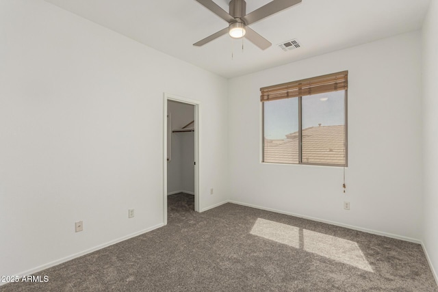 14604 W Banff Ln, Surprise, AZ 85379 - unfurnished bedroom featuring carpet, a walk in closet, baseboards, a closet, and ceiling fan