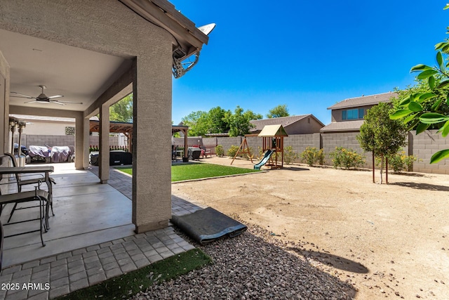 14604 W Banff Ln, Surprise, AZ 85379 - fenced backyard with ceiling fan, a playground, and a patio area