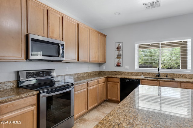 kitchen featuring light stone countertops, light tile patterned floors, appliances with stainless steel finishes, sink, and light brown cabinets