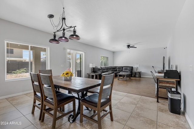 dining area featuring ceiling fan with notable chandelier and light wood-type flooring