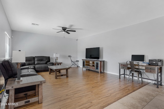 living room featuring light hardwood / wood-style flooring and ceiling fan