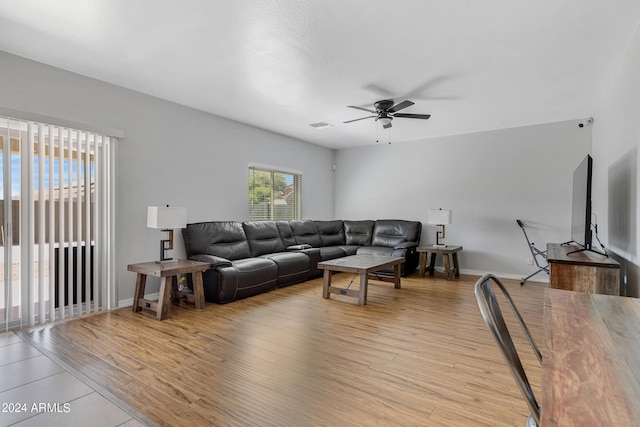 living room with ceiling fan and light wood-type flooring