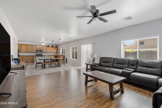 living room with ceiling fan and light hardwood / wood-style floors