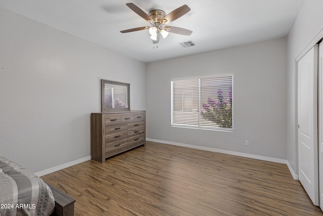 bedroom featuring hardwood / wood-style floors, ceiling fan, and a closet