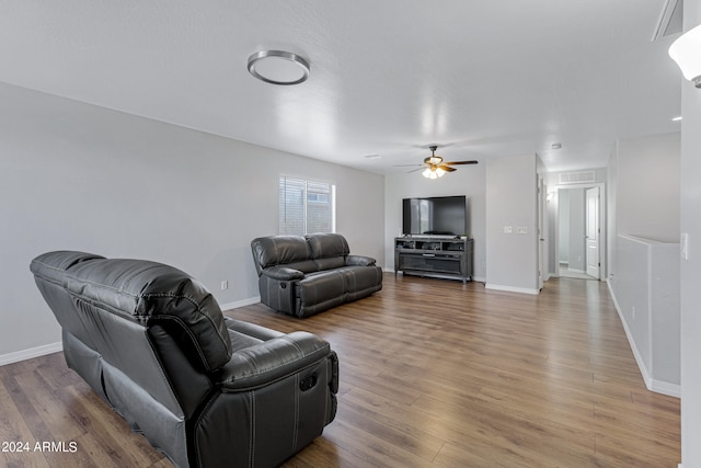 living room with ceiling fan and hardwood / wood-style flooring