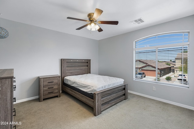 bedroom featuring ceiling fan and light carpet