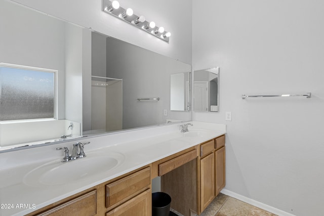 bathroom featuring vanity, walk in shower, and tile patterned flooring