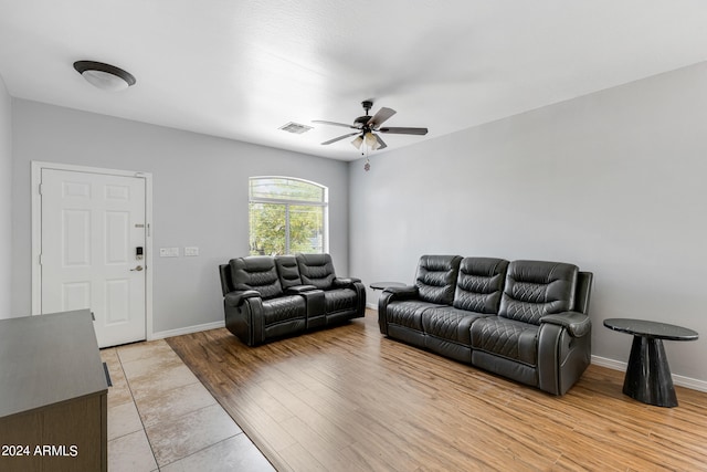 living room with ceiling fan and light wood-type flooring