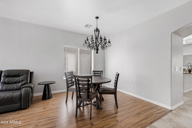 dining space with an inviting chandelier and hardwood / wood-style floors