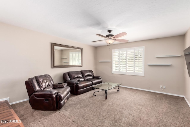 living room with carpet, baseboards, and ceiling fan