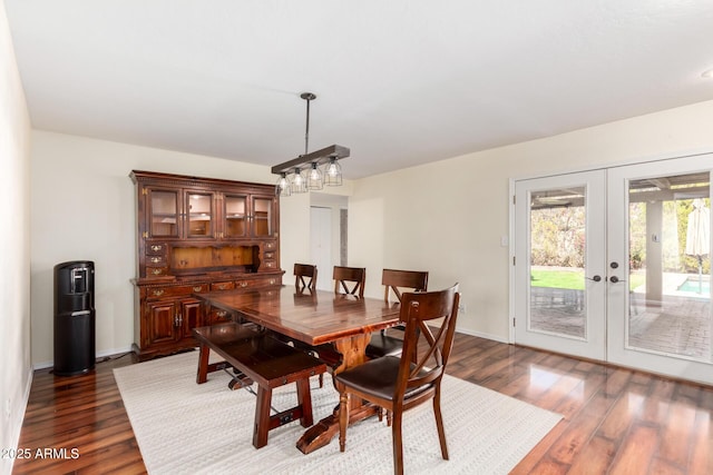 dining space with french doors, baseboards, and dark wood finished floors