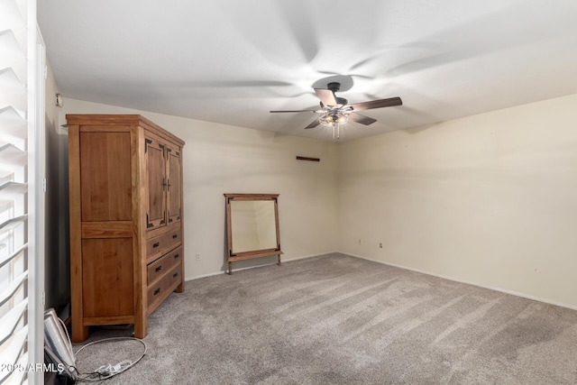 unfurnished room featuring light carpet and a ceiling fan