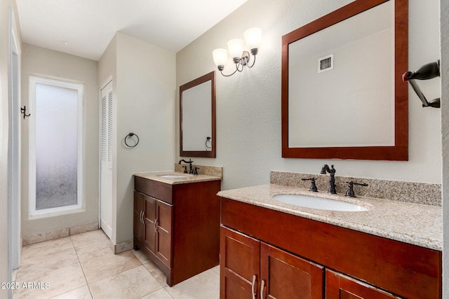 full bathroom with a sink, visible vents, two vanities, and tile patterned floors