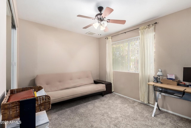 interior space with visible vents, carpet flooring, a ceiling fan, and baseboards