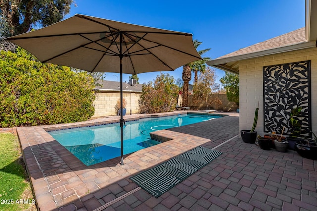 view of pool featuring a diving board, a fenced in pool, a patio, and a fenced backyard
