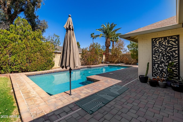 view of swimming pool with a fenced in pool, a patio, a fenced backyard, and a diving board