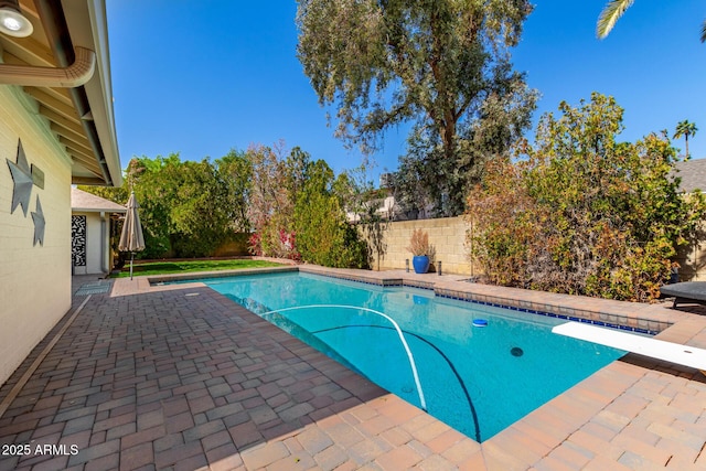 view of swimming pool with a fenced in pool, a fenced backyard, and a patio area