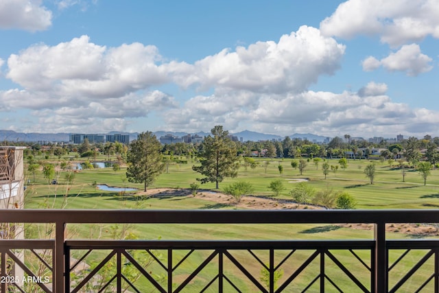 balcony with a water and mountain view and golf course view