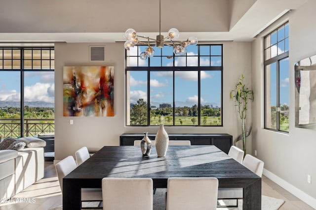 dining area with a chandelier and baseboards